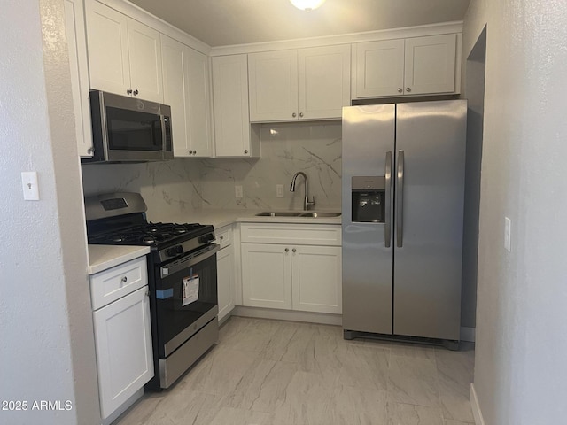 kitchen featuring a sink, stainless steel appliances, light countertops, marble finish floor, and backsplash