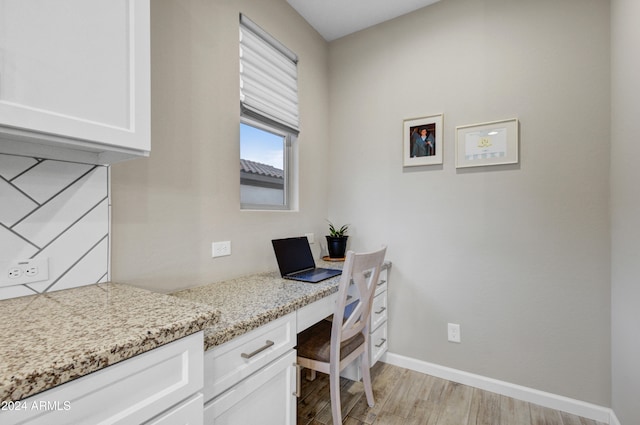 home office featuring built in desk and light wood-type flooring