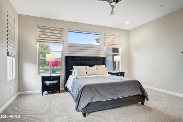 bedroom featuring light colored carpet and ceiling fan