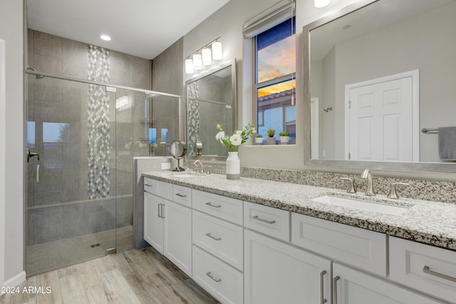 bathroom featuring vanity, wood-type flooring, and an enclosed shower