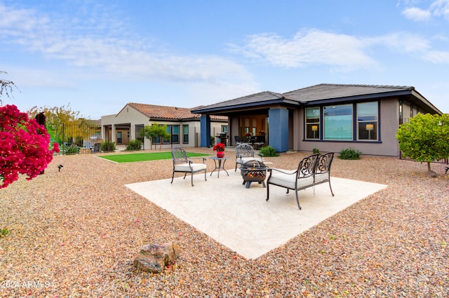 back of property featuring an outdoor fire pit