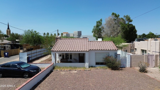 42 E 2nd Ave, Mesa, AZ 85210 - view of front facade with stucco siding, a tiled roof, a porch, and a gate