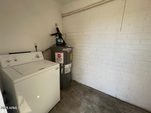 clothes washing area with laundry area, washer / clothes dryer, and electric water heater