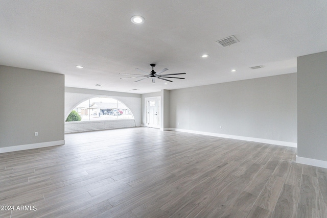 unfurnished living room featuring a textured ceiling, ceiling fan, and light hardwood / wood-style floors