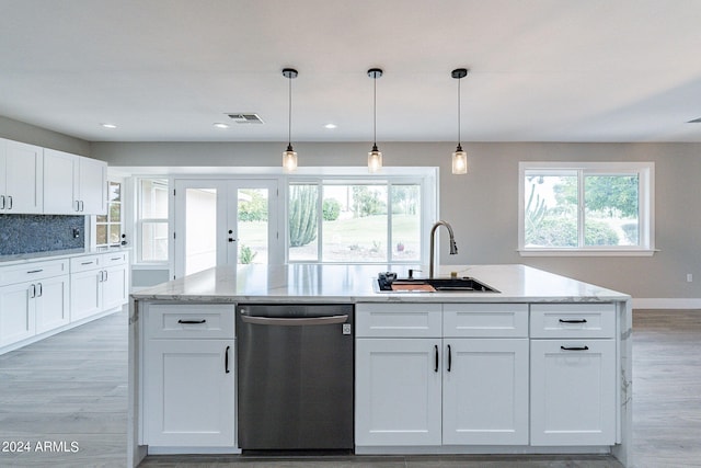 kitchen with hanging light fixtures, white cabinetry, sink, a center island with sink, and stainless steel dishwasher