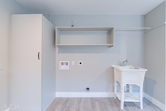 washroom featuring hookup for a washing machine, light hardwood / wood-style flooring, and electric dryer hookup