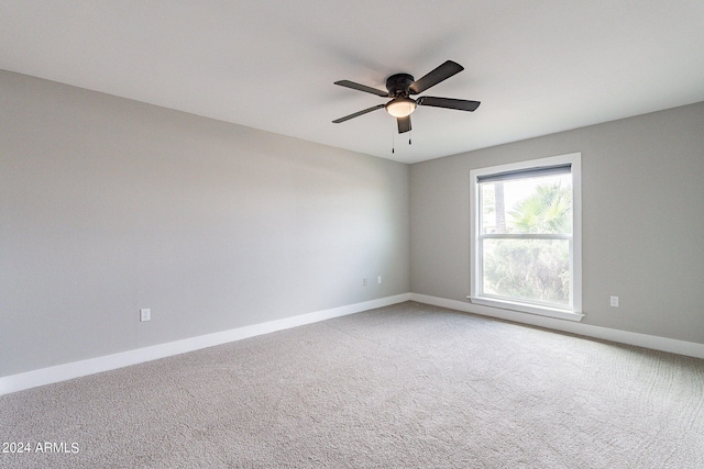 spare room featuring carpet flooring and ceiling fan