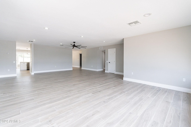 unfurnished living room featuring light hardwood / wood-style flooring and ceiling fan