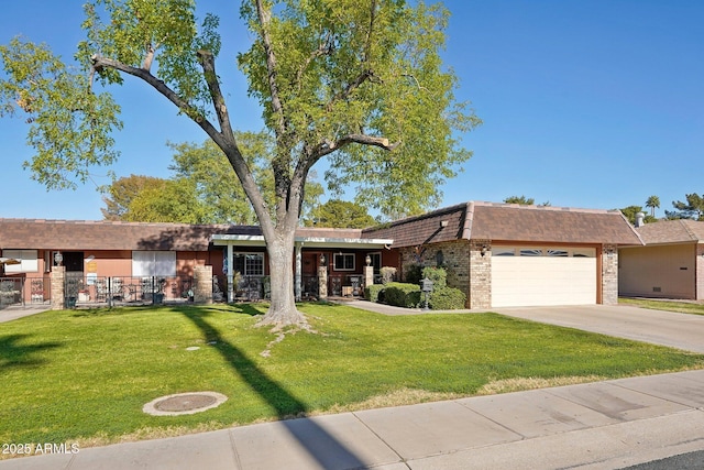 ranch-style home featuring a garage and a front lawn