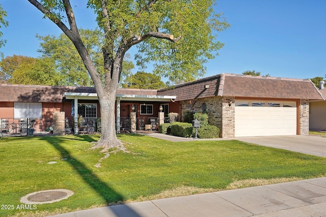 view of front of home with a garage and a front lawn