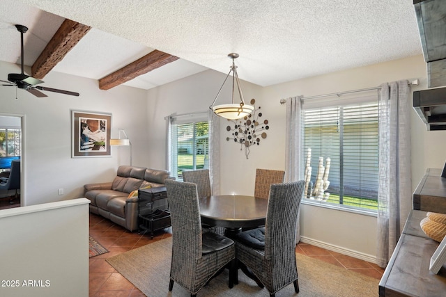 tiled dining room featuring beam ceiling, ceiling fan, and a textured ceiling