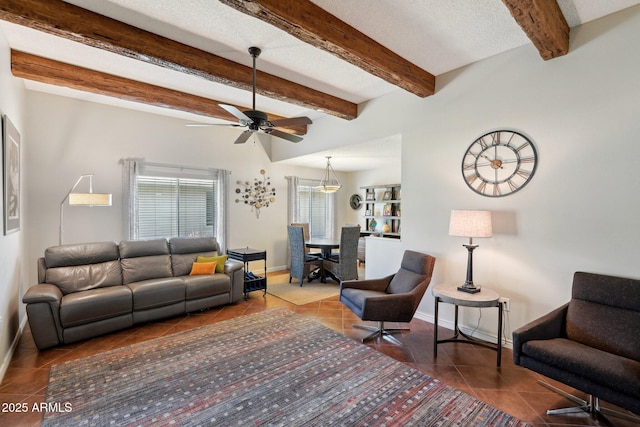 tiled living room with beamed ceiling, ceiling fan, and a textured ceiling