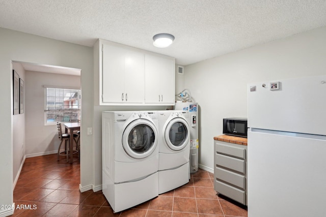 laundry room with electric water heater, separate washer and dryer, tile patterned flooring, and a textured ceiling