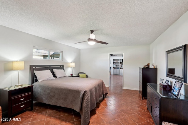 tiled bedroom featuring ceiling fan and a textured ceiling