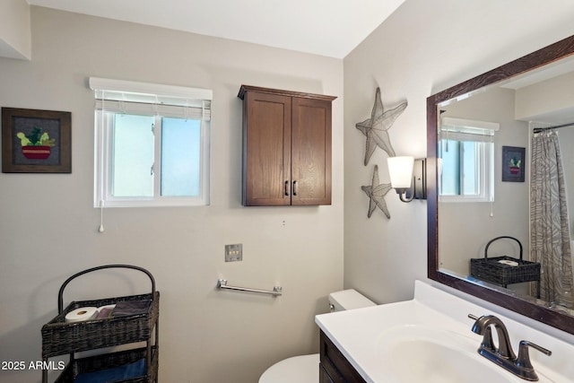 bathroom featuring vanity and toilet