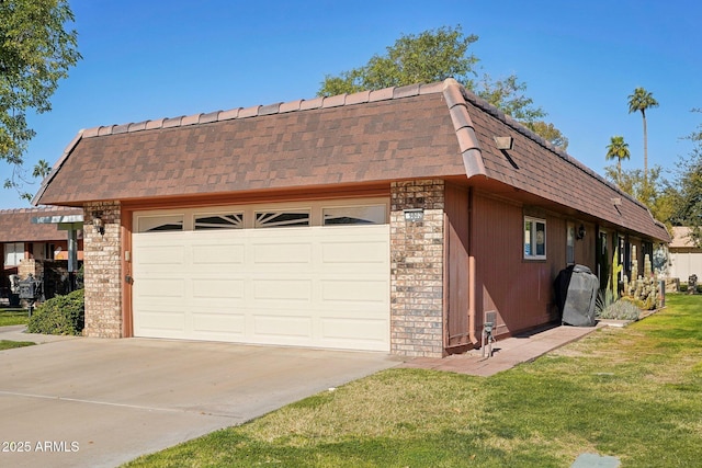 view of side of home featuring a garage and a yard