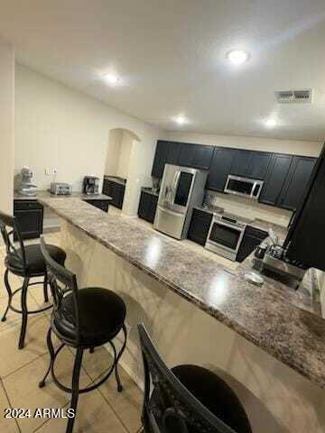 kitchen with light stone countertops and light tile patterned floors