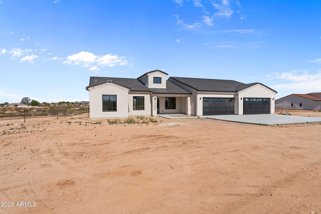 34256 S State Route 89th Hwy, Wickenburg, AZ 85390 - modern farmhouse style home featuring a garage, driveway, and stucco siding