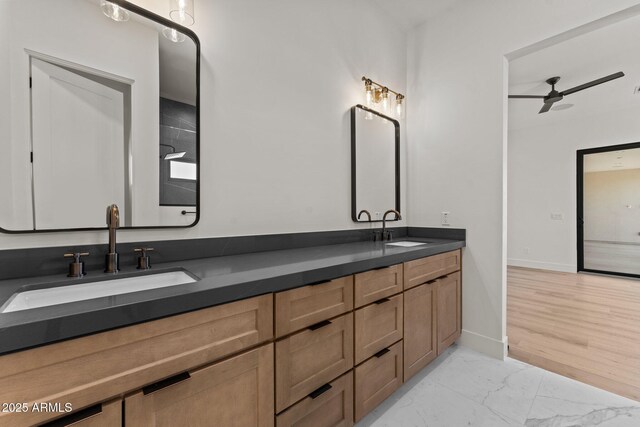 34256 S State Route 89th Hwy, Wickenburg, AZ 85390 - bathroom featuring a ceiling fan, marble look tile flooring, double vanity, and baseboards
