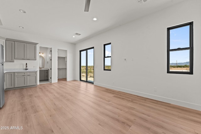 34256 S State Route 89th Hwy, Wickenburg, AZ 85390 - unfurnished living room featuring baseboards, light wood-type flooring, recessed lighting, and ceiling fan