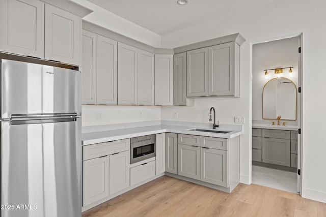 34256 S State Route 89th Hwy, Wickenburg, AZ 85390 - kitchen featuring freestanding refrigerator, a sink, gray cabinetry, and light countertops