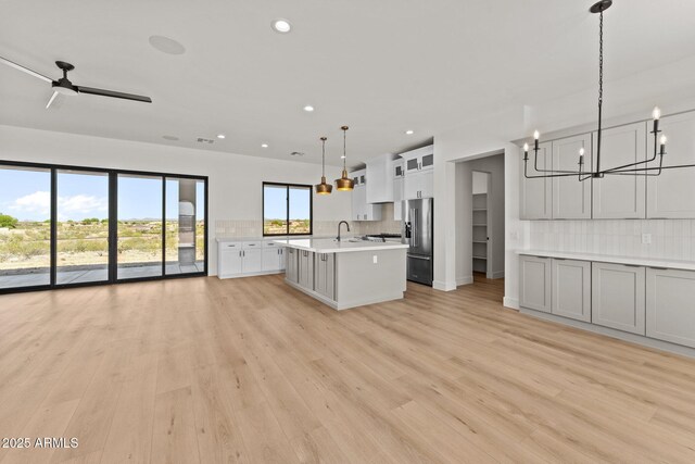 34256 S State Route 89th Hwy, Wickenburg, AZ 85390 - kitchen featuring high quality fridge, a chandelier, light countertops, backsplash, and open floor plan
