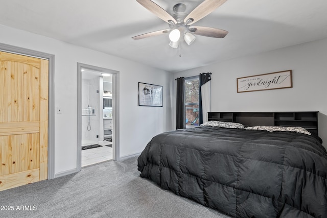 bedroom with ensuite bathroom, baseboards, carpet floors, and ceiling fan