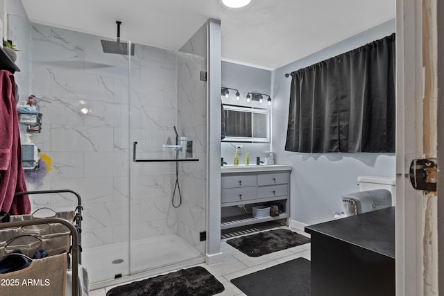 bathroom featuring a marble finish shower and vanity