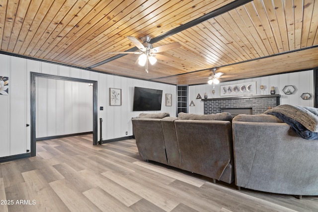 living room with wood finished floors, a fireplace, wooden ceiling, and ceiling fan