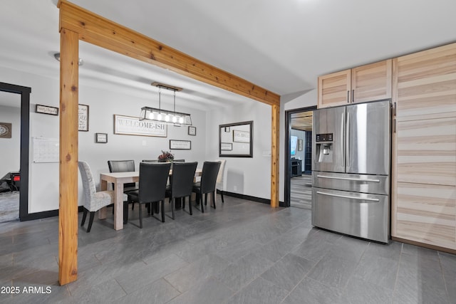 dining area with beam ceiling and baseboards