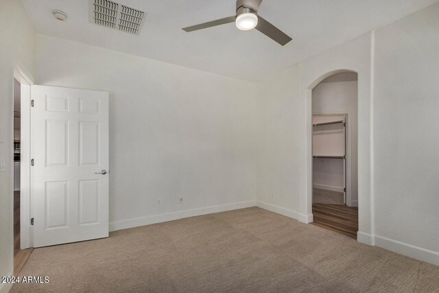 spare room with light carpet and ceiling fan