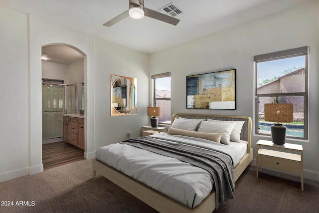 carpeted bedroom featuring ensuite bathroom and ceiling fan