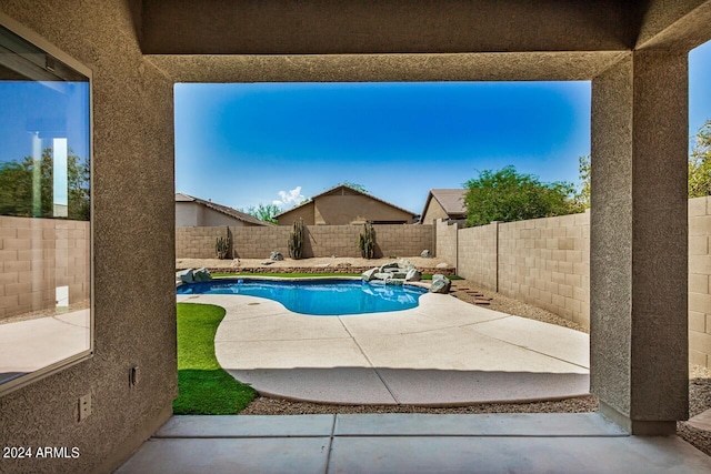 view of swimming pool with a patio