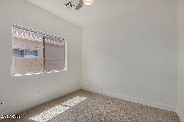 empty room with carpet floors and ceiling fan