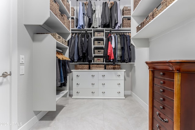 walk in closet with light tile patterned flooring