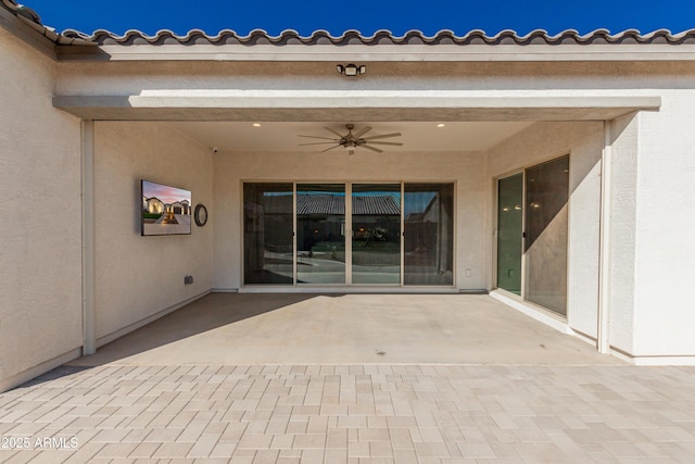 doorway to property featuring a patio and ceiling fan