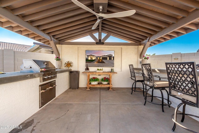 view of patio / terrace featuring grilling area, area for grilling, ceiling fan, and a bar