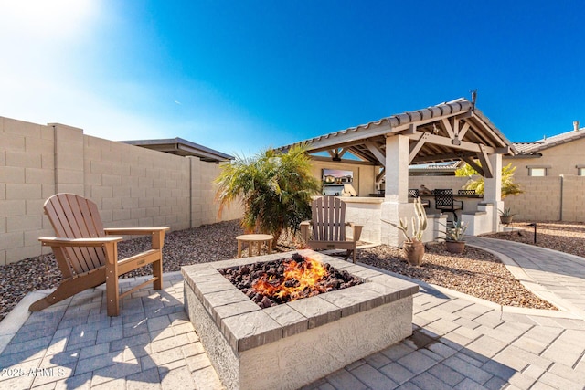 view of patio featuring a gazebo and a fire pit