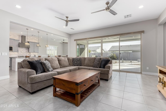 tiled living room featuring ceiling fan