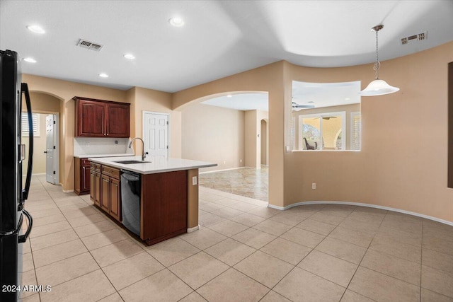 kitchen featuring sink, hanging light fixtures, stainless steel dishwasher, fridge, and a kitchen island with sink