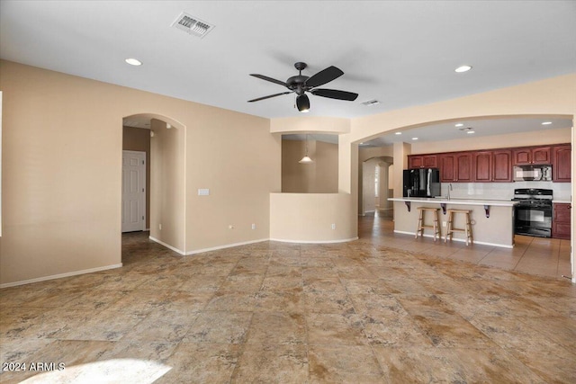 unfurnished living room with ceiling fan