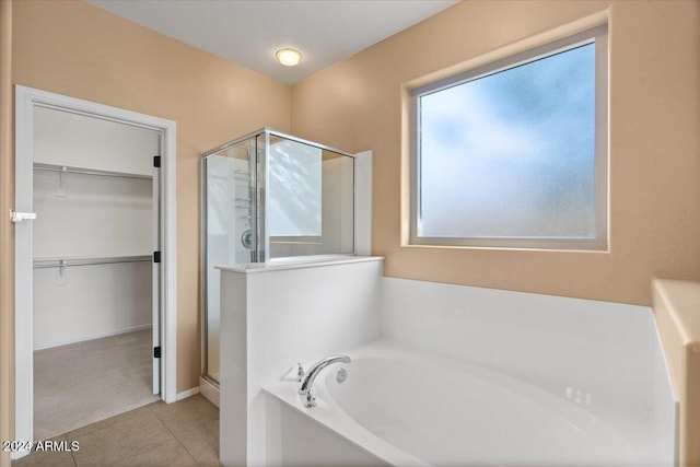 bathroom with separate shower and tub and tile patterned floors