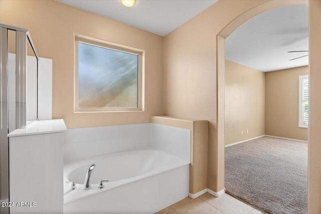 bathroom with a bathtub and tile patterned flooring