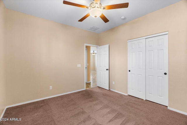 unfurnished bedroom featuring ceiling fan, carpet floors, and a closet