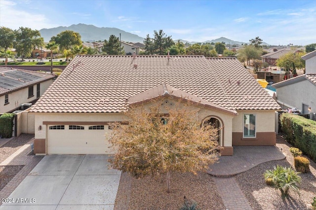 view of front of home with a mountain view and a garage