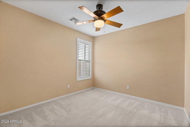 unfurnished room featuring light carpet