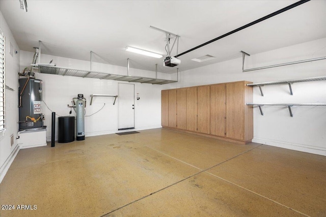 garage featuring gas water heater and a garage door opener