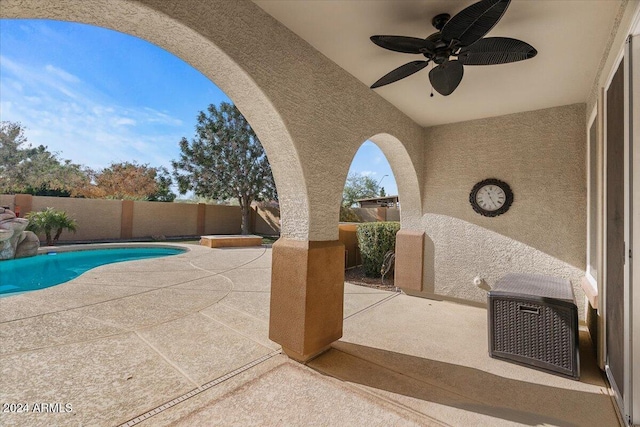 exterior space with ceiling fan and a fenced in pool