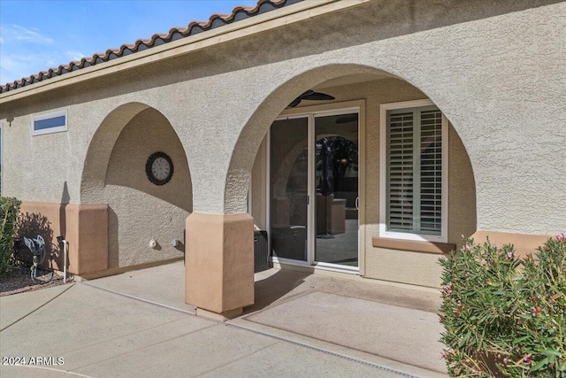 property entrance with a patio area