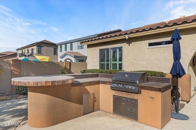 view of patio featuring a grill and exterior kitchen